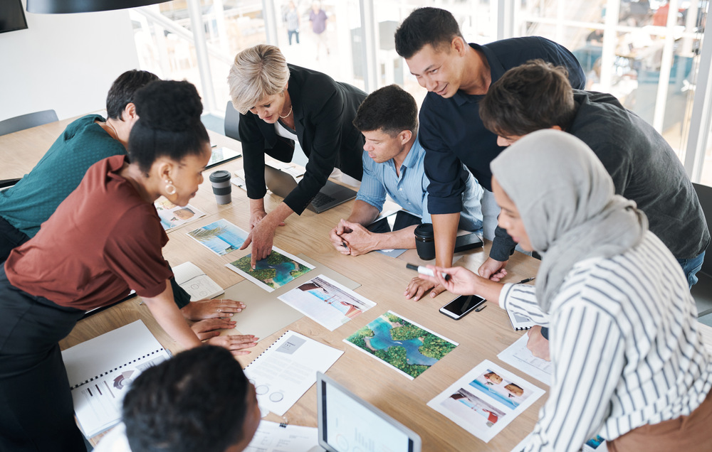 Shot of a group of businesspeople discussing paperwork during a meeting in a modern office.